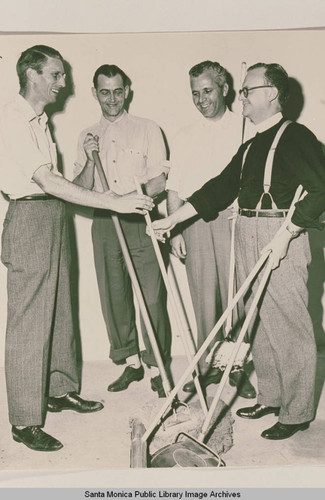 Men holding cleaning equipment, Pacific Palisades, Calif