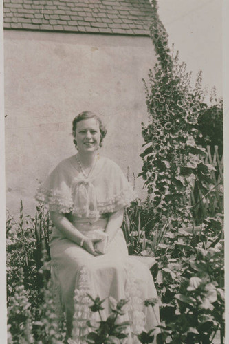 Portrait of Frances Stewart seated in Marjorie Wilson's garden on Fiske Street in Pacific Palisades
