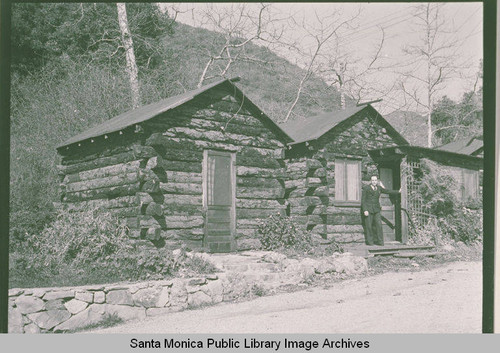 A man standing in front of Casitas at the Institute Camp in Temescal Canyon, Calif