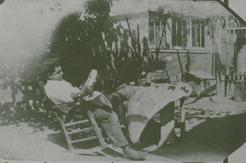 Member of the Marquez Family relax in a rocking chair in front of a house in Santa Monica Canyon