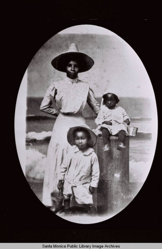 Selena Brunson with sons Vernon Brunson (seated) and Donald Brunson (standing) posed for a photograph on the Santa Monica Pier in 1909