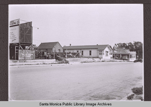 Looking south on Second Street towards Colorado Avenue and the arroyo showing the Veranda Apartments on the corner of Second Street and Colorado Avenue and a "Lincoln Shock Absorber" billboard, Santa Monica, Calif