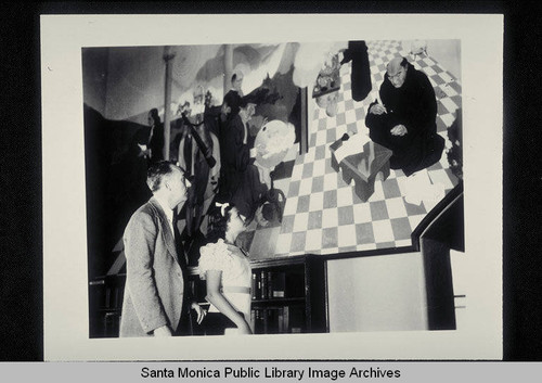 Stanton Macdonald-Wright with Barbara Douglas, daughter of Donald Douglas, at the installation and unveiling of his murals August 25, 1935, painted for the Santa Monica Public Library at Santa Monica Blvd. and Fifth Street