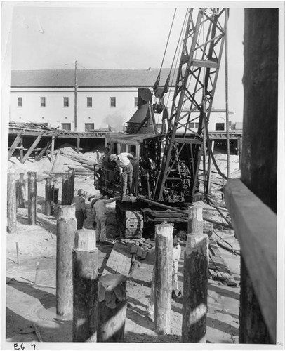 Construction workers and equipment at the site of Pacific Ocean Park's Sea Circus attraction, Santa Monica, Calif