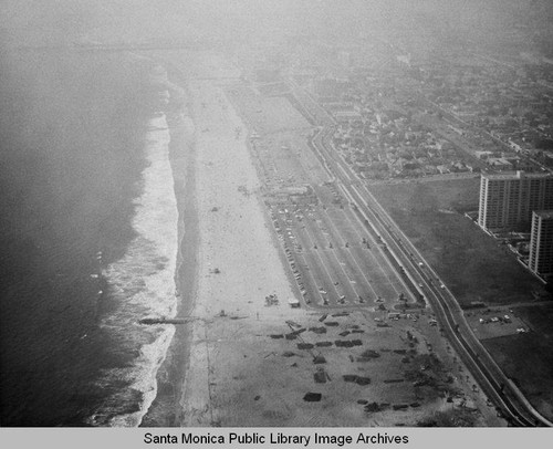 Looking north from the remains of the Pacific Ocean Park Pier to beach parking lots and the Santa Monica Shores Apartments in the fog, July 16, 1975