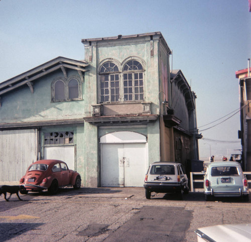 Cars parked near the back of Merry-go-round building on Santa Monica Pier