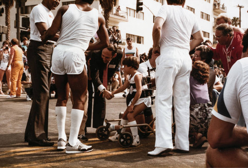 Santa Monica Mayor Ken Edwards holding Michael Bailey's hand at Olympic torch relay on July 21, 1984, Santa Monica, Calif