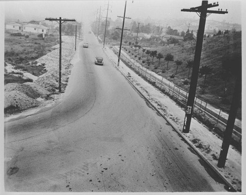 Automobiles drive by drainage route from Santa Monica Municipal Airport, January 19, 1953