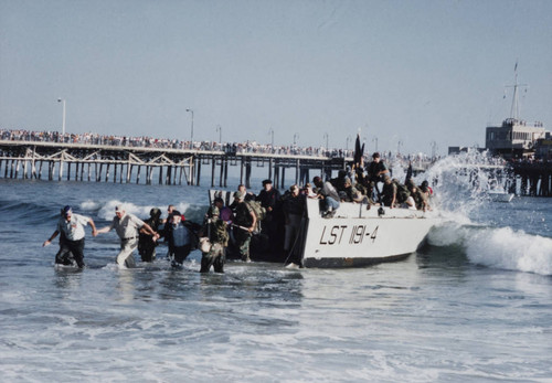 Soldiers helping veterans disembark during the reenactment of D-Day landing, Santa Monica, Calif