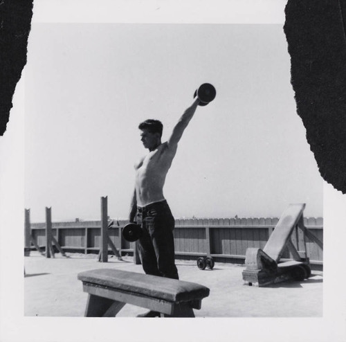 Man lifting weights on Muscle Beach, Santa Monica, Calif