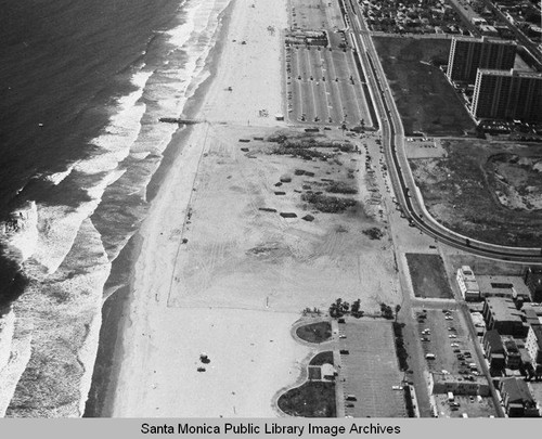 Looking north from the remains of the Pacific Ocean Park Pier to beach parking lots and the Santa Monica Shores Apartments, June 18, 1975, 2:00 PM