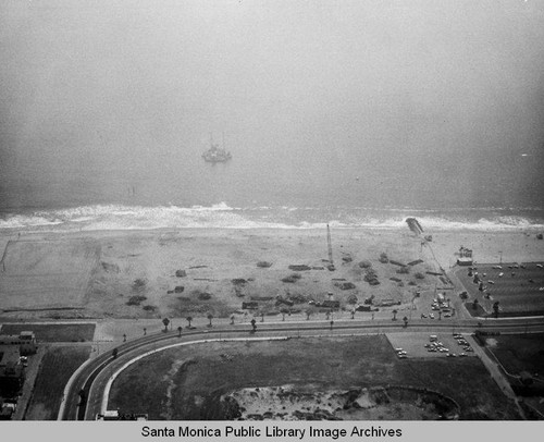 View of the remains of the Pacific Ocean Park Pier looking west to a barge in Santa Monica Bay in the fog, July 16, 1975