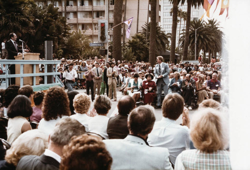 People gathered around the stage to hear Ken Edwards speak at Olympic torch relay on July 21, 1984, Santa Monica, Calif