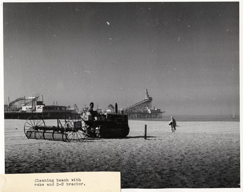 Beach cleaning with rake and a D-2 tractor, Santa Monica, Calif