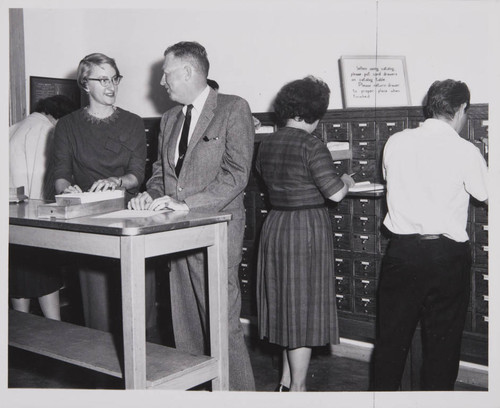 Librarian Joan Van Every assisting Crosby Maynard of Douglas Aircraft Company with the card catalog