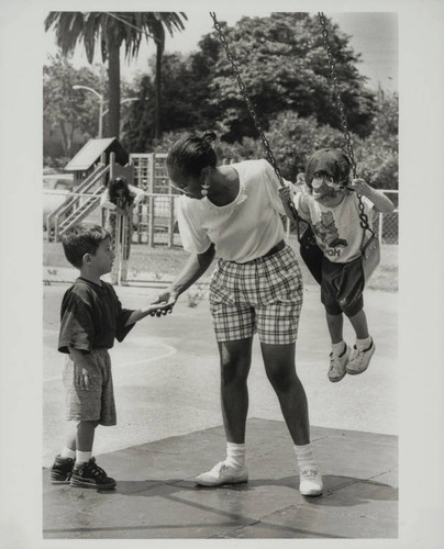 Teacher and two children on the playground, John Adams School, Santa Monica, Calif