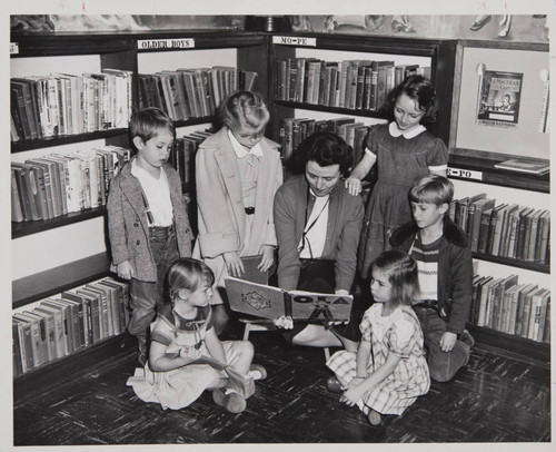 Librarian Mary Margaret Dyer with her young friends during story time