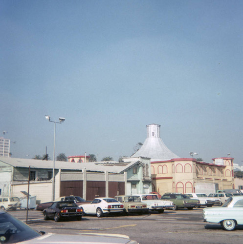 Cars parked in a lot near Merry-go-round building on Santa Monica Pier