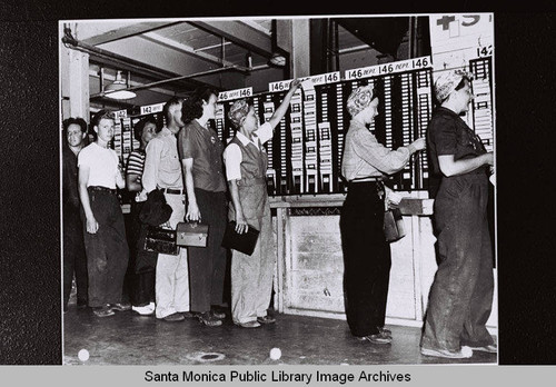 Douglas Aircraft Company Santa Monica plant employees line up to punch their timecards during World War II