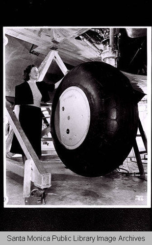 Woman with landing gear extended on a Douglas DC-4, May 28, 1938