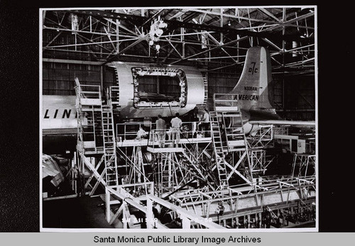 DC-7 cargo door being lowered into Douglas Aircraft Company Santa Monica plant (American Airlines N335AA) on September 2, 1959