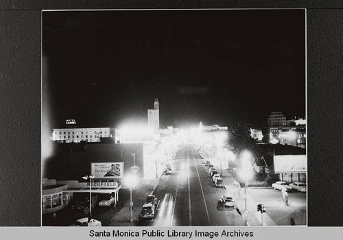 Street lights (before mercury vapor lights) looking toward Richfield Gas and the Hotel Carmel from Third Street and Colorado Avenue, Santa Monica, Calif., March 31, 1955