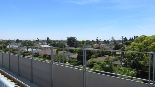 Houses and trees along the track near Expo Line Expo/Bundy station, April 28, 2017