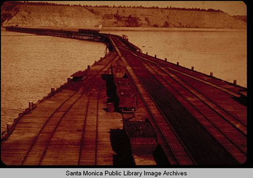 Long Wharf looking toward the shore and coal cars on the Southern Pacific Railroad tracks