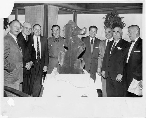 Investors and other principal figures involved in the Pacific Ocean Park project surround a sea creature sculpture, Santa Monica, Calif