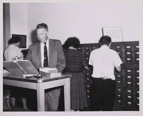 Crosby Maynard doing research in the library