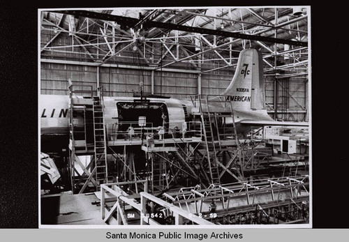 Assembling the cargo door of American Airlines DC-7 plane in the Douglas Aircraft Company Santa Monica plant, September 2, 1959