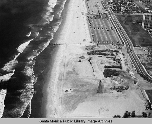 Looking north from the remains of the Pacific Ocean Park Pier at beach parking lots and the Santa Monica Shores Apartments, May 7, 1975, 1:00 PM