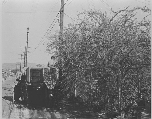 Santa Monica City Sanitation Division worker with street sweeper cleaning alley