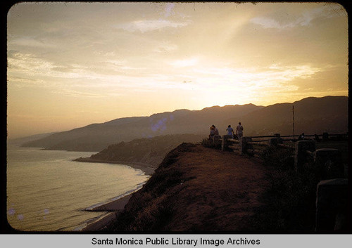 People admiring the view of Santa Monica Bay at sunset from Palisades Park