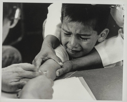 Boy receiving a vaccination shot, Latino Resource Organization, Santa Monica, Calif