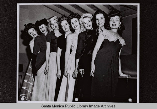 Women wearing evening dresses for a Douglas Aircraft Company employees dance