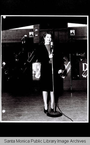 Woman at the microphone with the Douglas Aircraft Company band during World War II