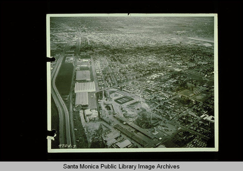 Aerial looking east at Santa Monica, Calif. with Olympic Blvd. on the left, Clover Field Airport at right, and the City Yards in foreground, December 2, 1955 /California Division of Highways and Public Works