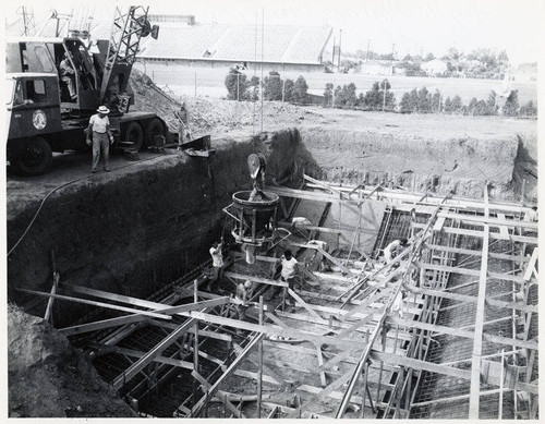 Construction of the Santa Monica Municipal Pool showing workers placing concrete in the south footing of diving pool, August 11, 1950