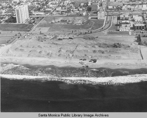 Looking east from the remains of the Pacific Ocean Park Pier to sand berms and the Santa Monica Shores high-rise, October 28, 1975