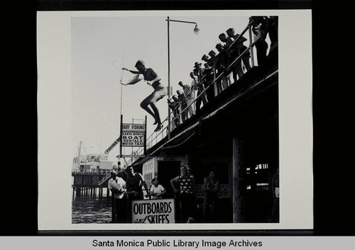 Santa Monica Recreation Department Junior Lifeguards jumping off the Santa Monica Pier on August 31, 1955