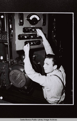 Douglas Aircraft Company Santa Monica plant employee, Harry Schooler, with machine dials during World War II