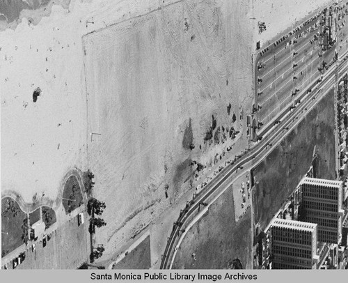 Looking north from the remains of the Pacific Ocean Park Pier to beach parking lots and Santa Monica Shores Apartments, August 29, 1975