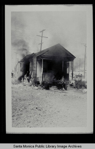 Burning a derelict house on Belmar Place between Main and Third Streets, north of Pico, on July 1, 1953