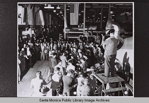 Band with a tuba player standing on a platform at the Douglas Aircraft Company plant in Santa Monica during World War II