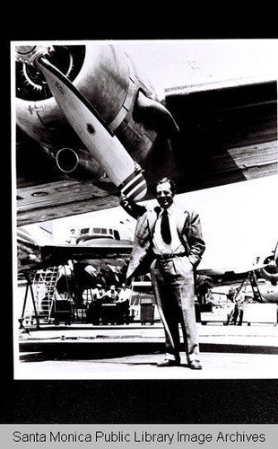 Portrait of Donald W. Douglas under the wing of a McDonnell Douglas plane