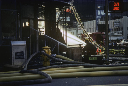 Firefighters battling a blaze at Thrifty Drug Store at 326 Wilshire Blvd