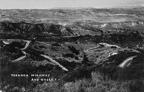 Roads winding through Topanga Canyon with a vew of San Fernando Valley in the background