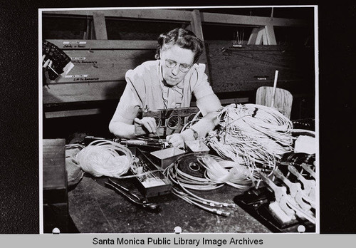 Douglas Aircraft Company Santa Monica plant employee working with wire, World War II