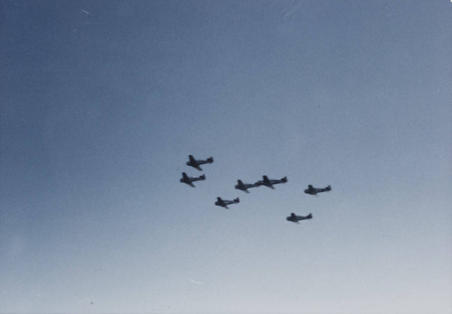 Vintage World War II era fighter planes flying overhead during the reenactment of D-Day landing, Santa Monica, Calif